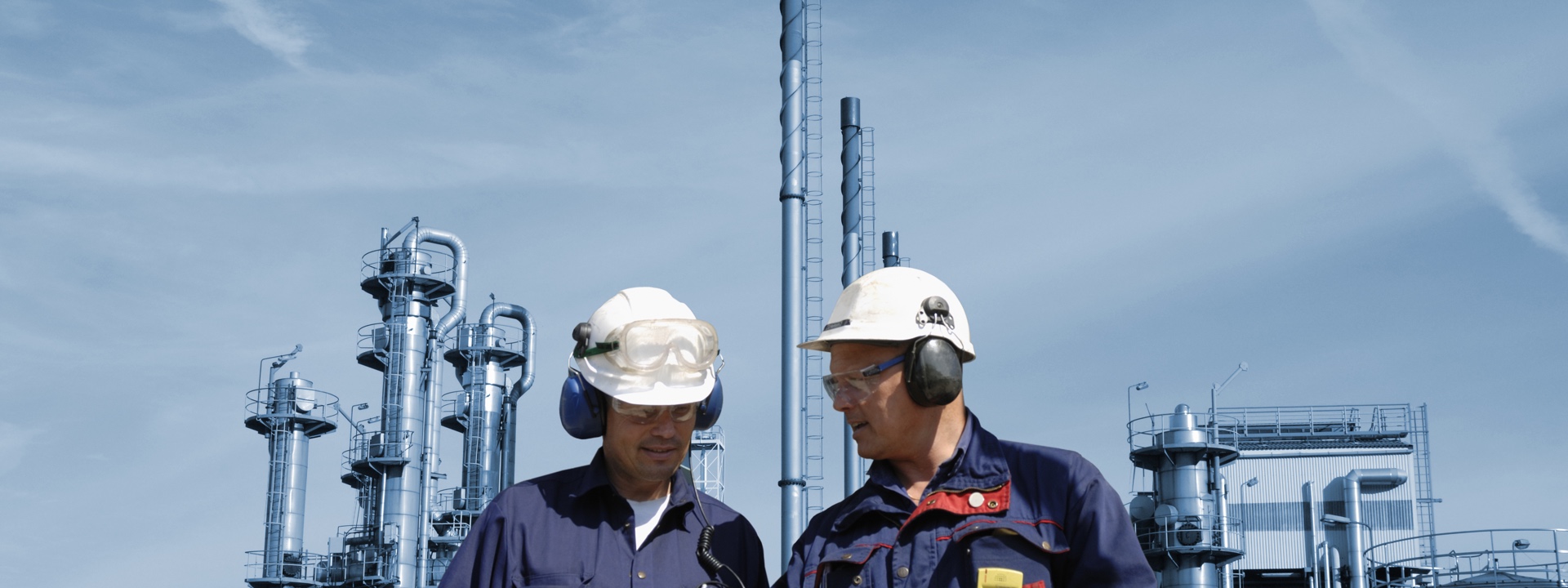 Two men workers having a discussing in front of a factory