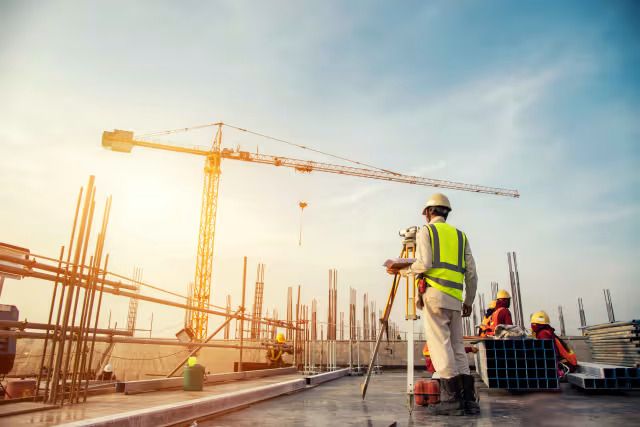 Construction worker surveying site