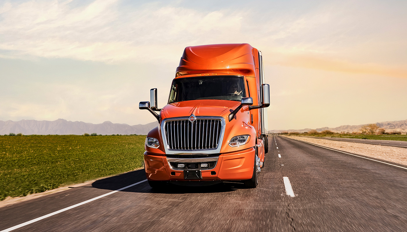 Orange commercial truck on a road