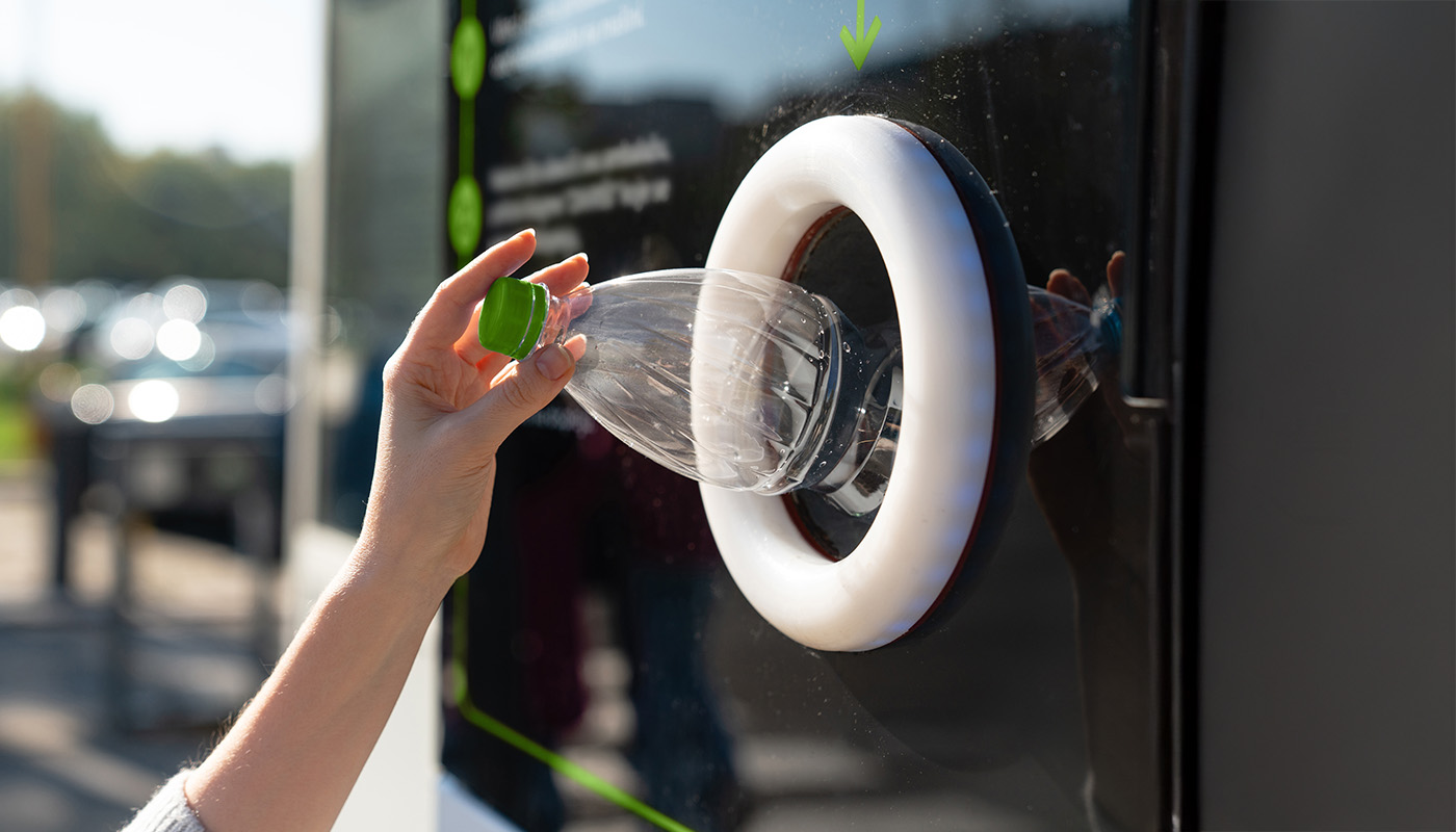 Person recycling plastic bottle