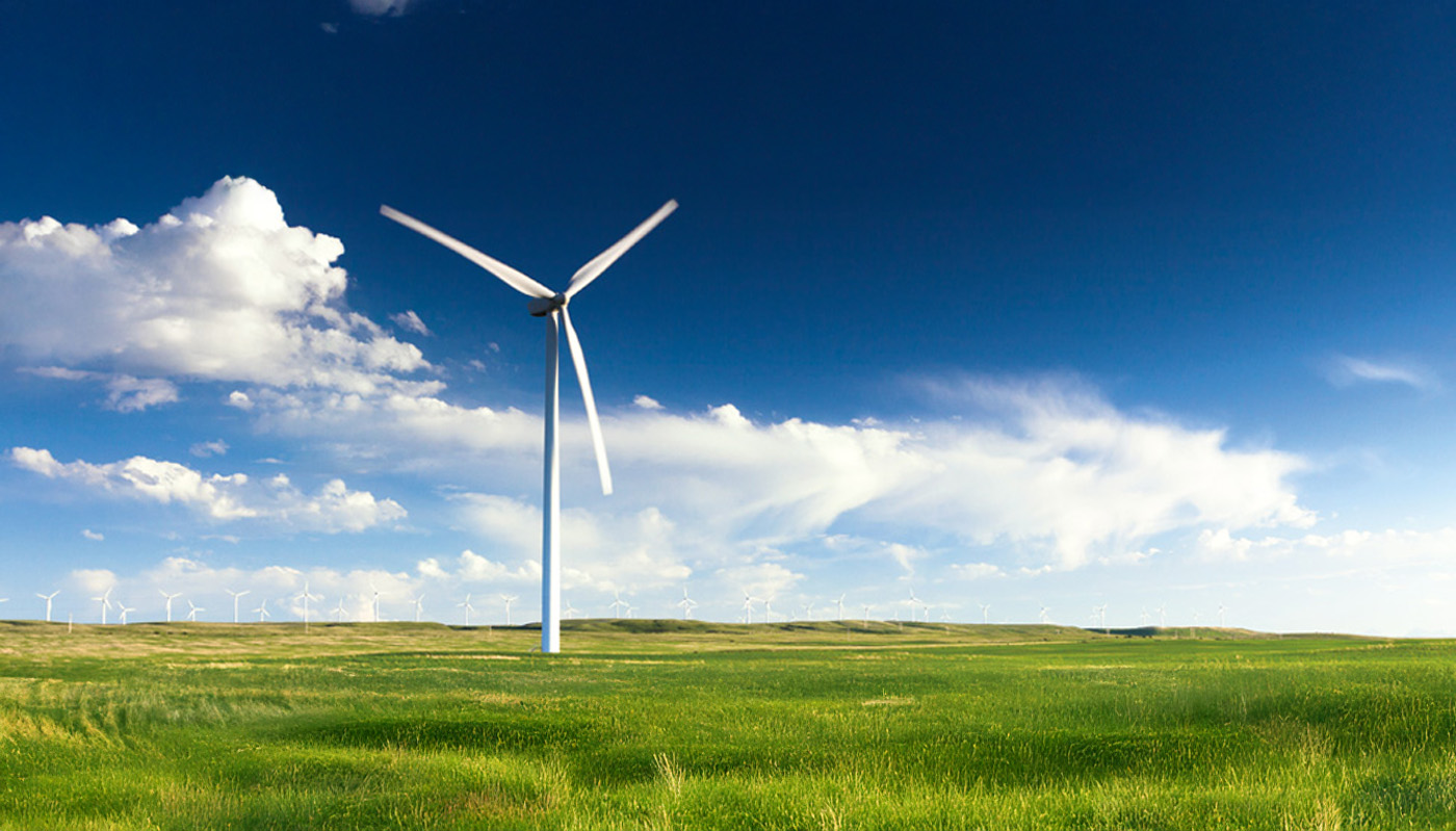 Wind turbine on grass field for energy generation
