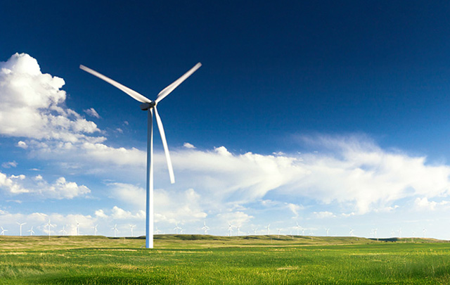 Wind turbine on grass field for energy generation